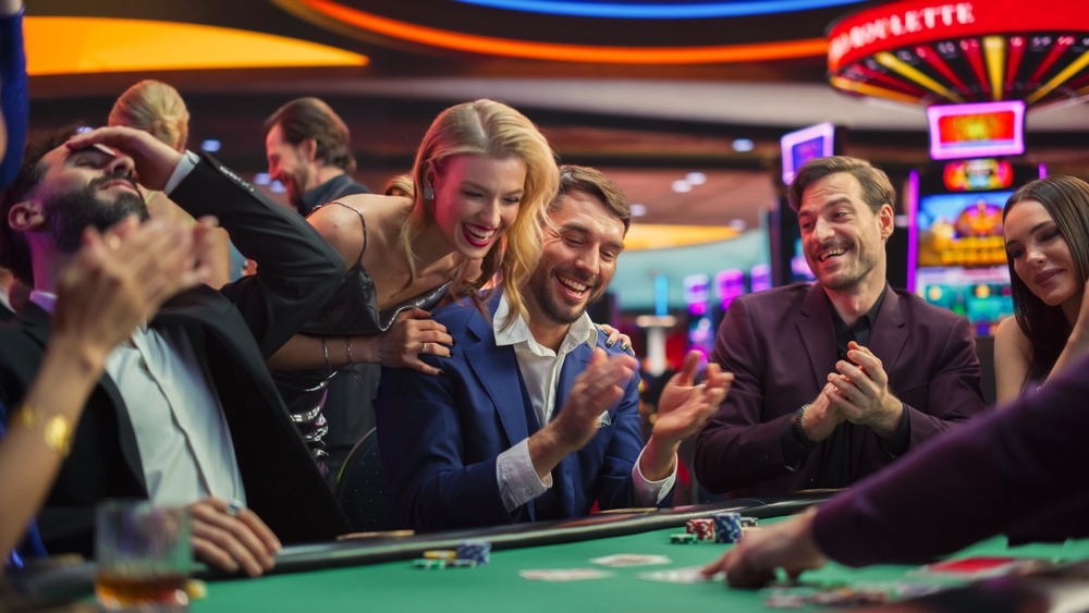 A casino player celebrating at a card table.