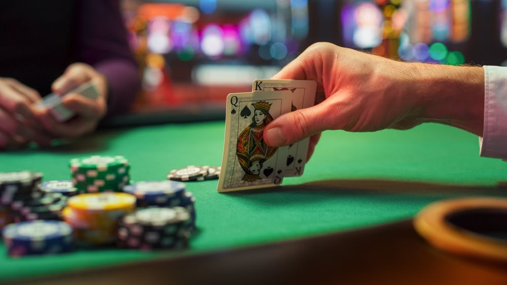 Blackjack hand totaling 20 on the table next to chips.
