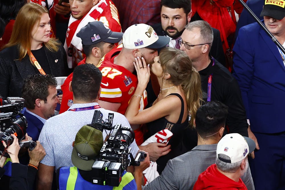 Kansas City Chiefs tight end Travis Kelce (87) kisses girlfriend Taylor Swift as he celebrates winning the game during Super Bowl LVIII between the Kansas City Chiefs and the San Francisco 49ers.