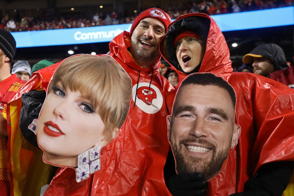 Kansas City Chiefs fans hold giant cutouts of Taylor Swift and Travis Kelce during an NFL football game between the Philadelphia Eagles and Kansas City Chiefs. 