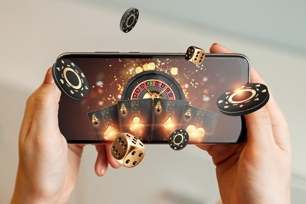 Online casino play with dice, chips, card, and a roulette table on a phone. 
