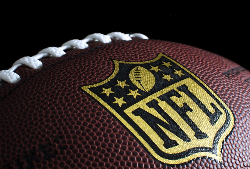 Close up of an NFL football with the NFL logo. 