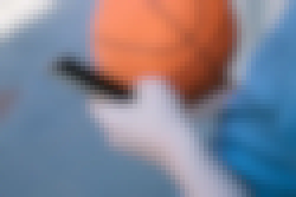 Someone placing a bet on basketball through their phone by betting online.