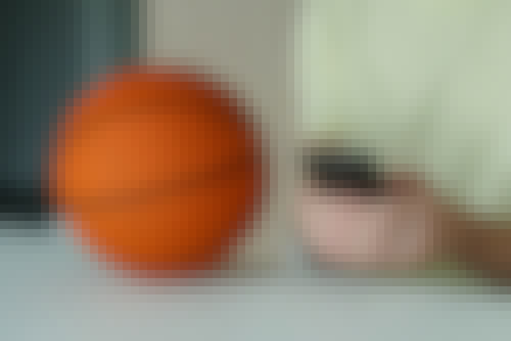 Someone placing a sports bet next to a basketball.