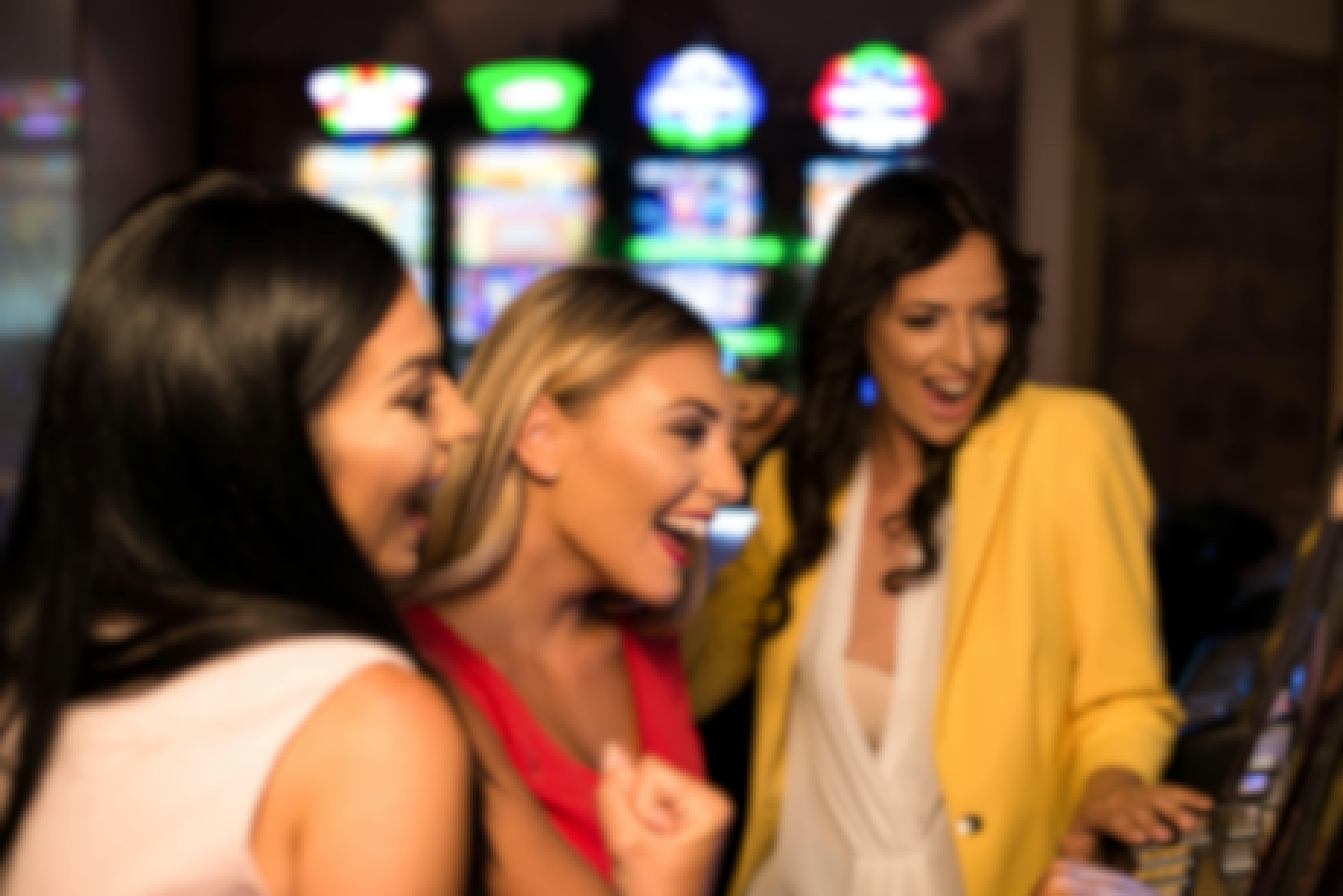 Three women enjoying a slot game.