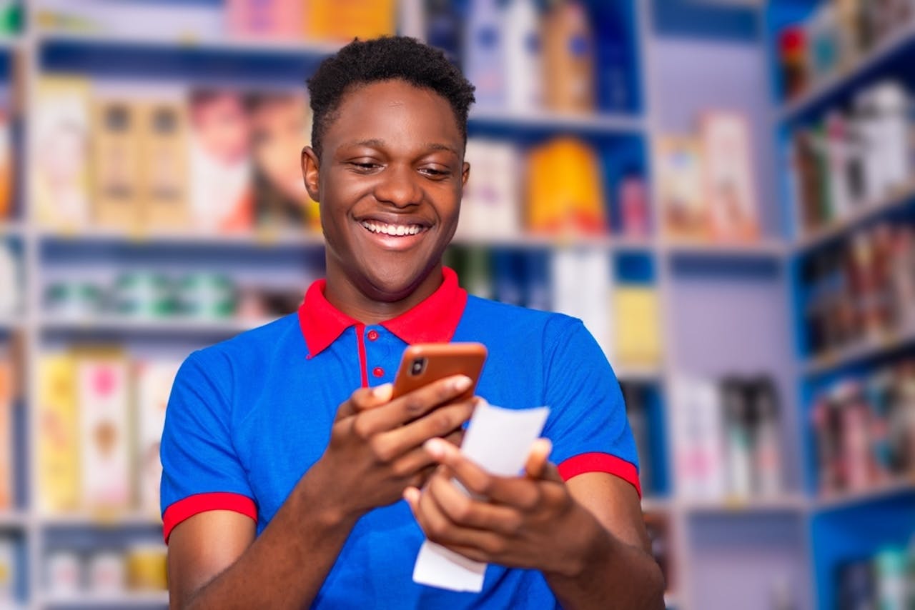 Photo of a man iwth his phone enjoying sports betting. 