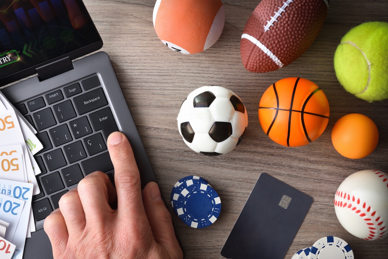 Representations of sports balls next to a computer. 