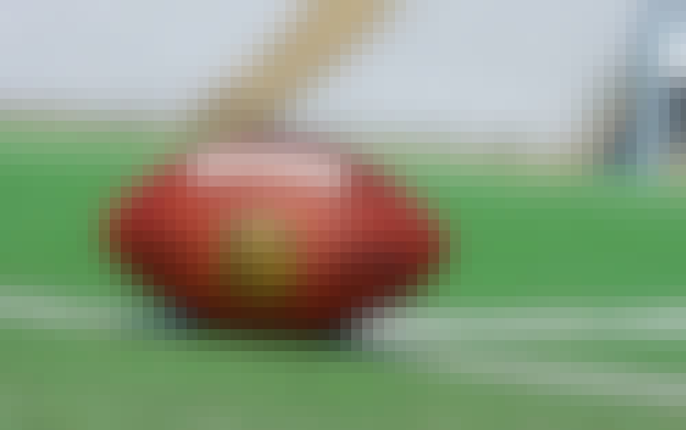 NFL ball placed on a football field.